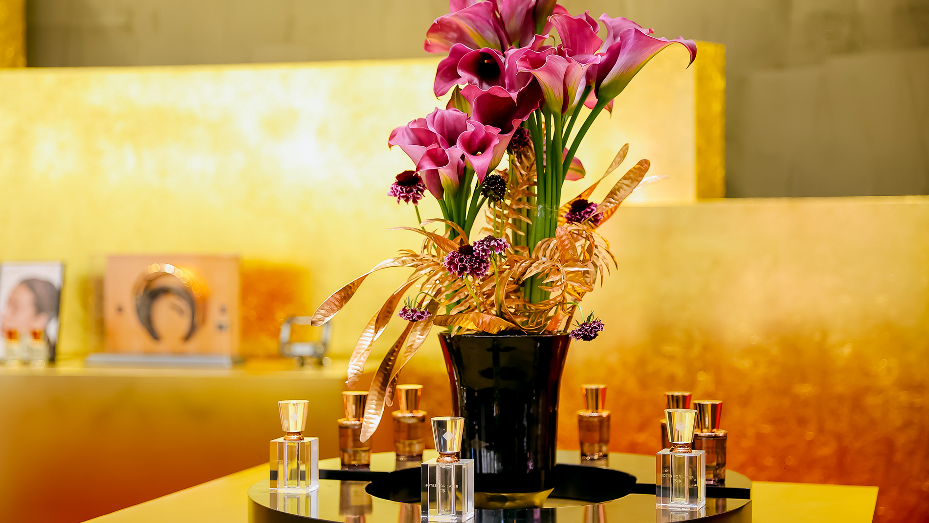 Notes Dubai - Perfume bottles on display with bouquet of flowers